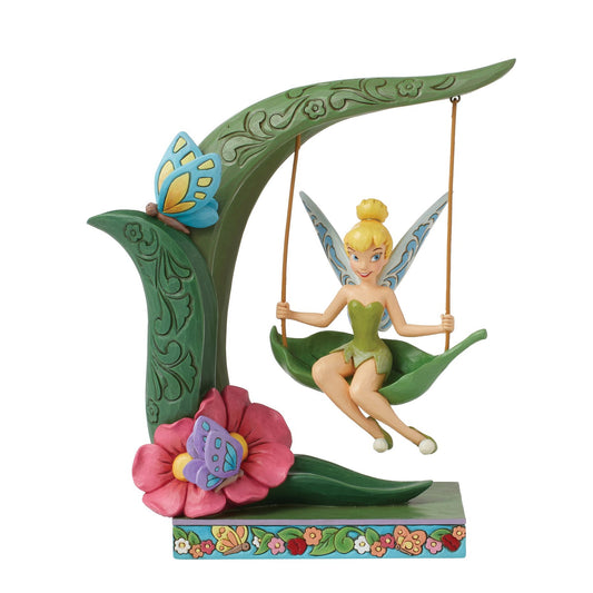 Tinker Bell figurine seated on a leaf swing from a curved stem, blue butterfly, pink flower, floral painted base