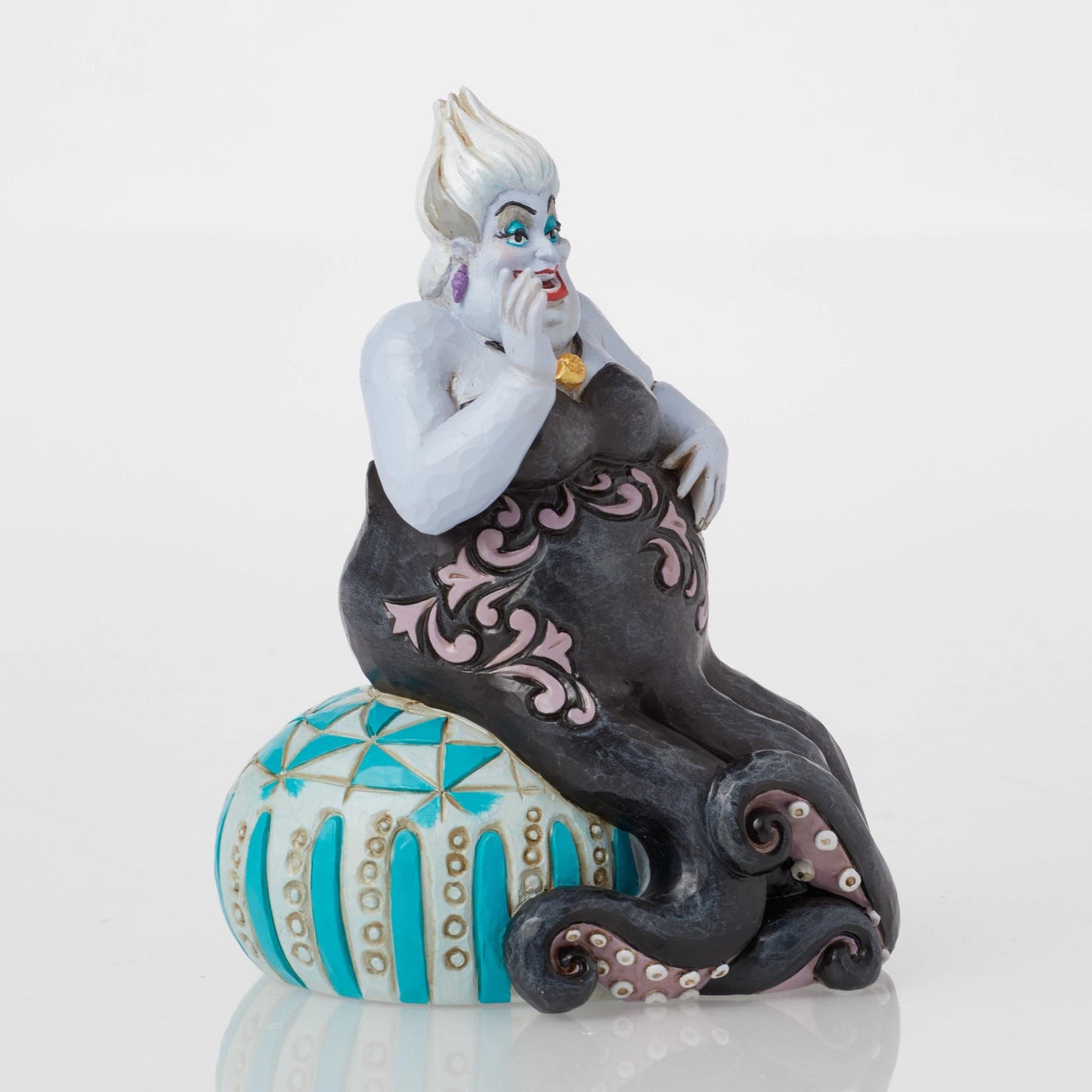 Side view of Ursula figurine with hand to chin, black tentacles with pink scrollwork, teal painted base 