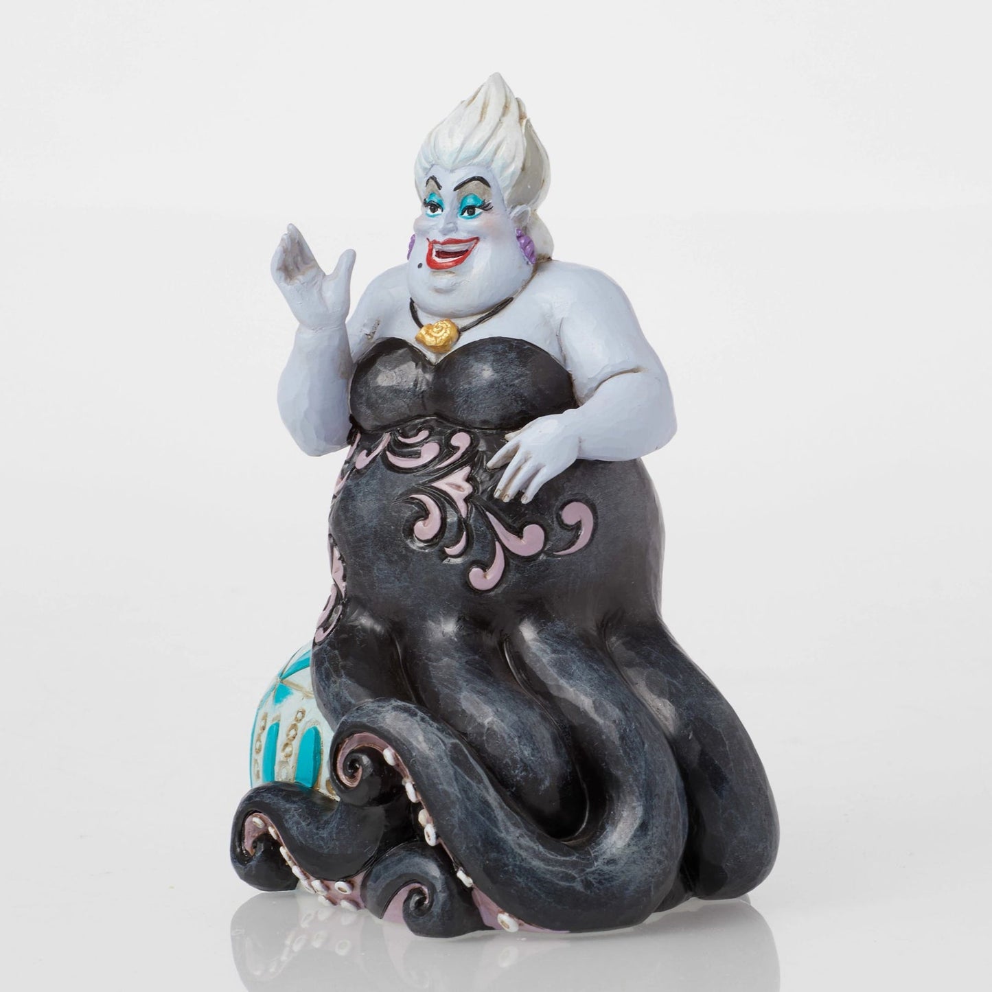 Front view of Ursula figurine from The Little Mermaid, black tentacles, pink scrollwork, gold necklace, teal base