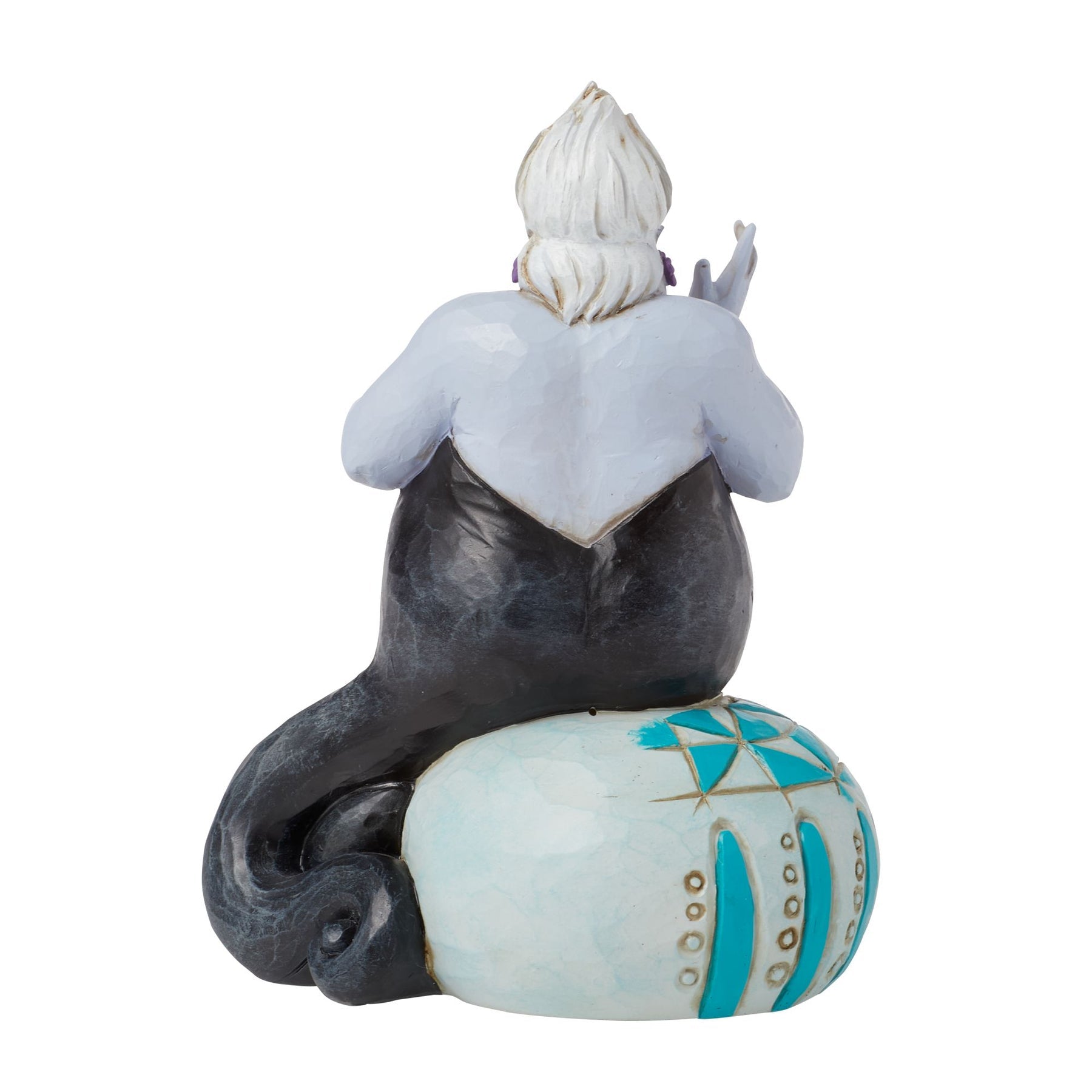 Rear view of Ursula figurine showing black tentacle body and teal painted orb base, white sculpted hair