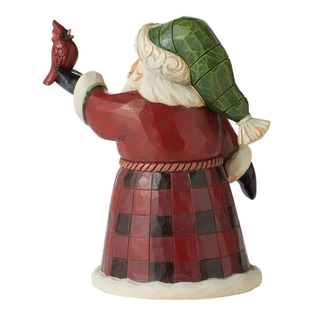 Rear view of Santa figurine in green tasselled hat and red plaid robe, arm outstretched holding a red cardinal bird