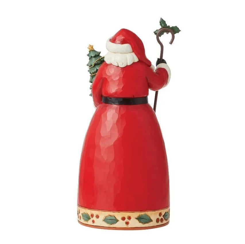 Rear view of Santa figurine in red coat holding a holly-topped staff and small Christmas tree, holly-decorated hem border
