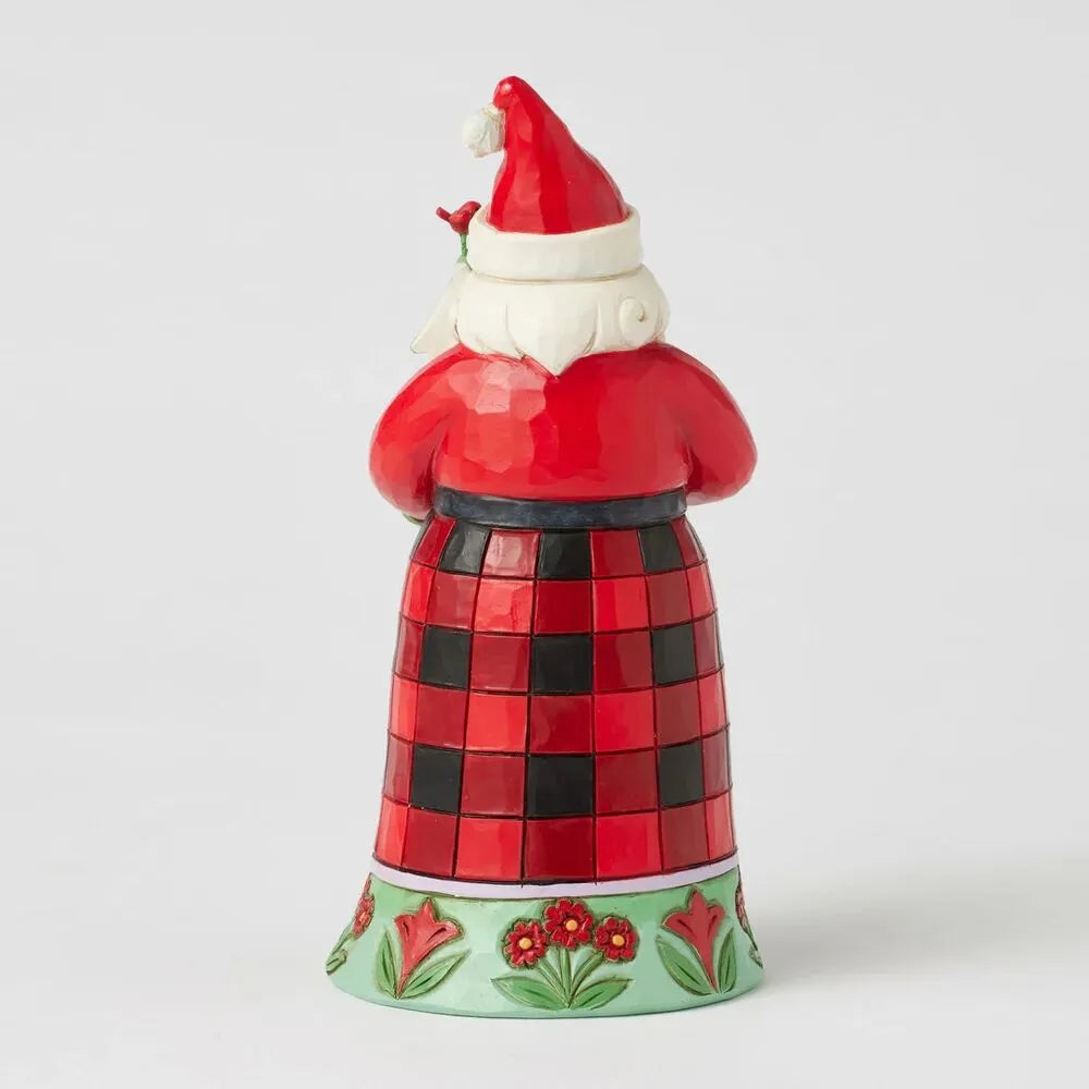 Rear view of a Jim Shore Santa figurine in a bold red and black check robe with a cardinal perched on the hat, on a floral base