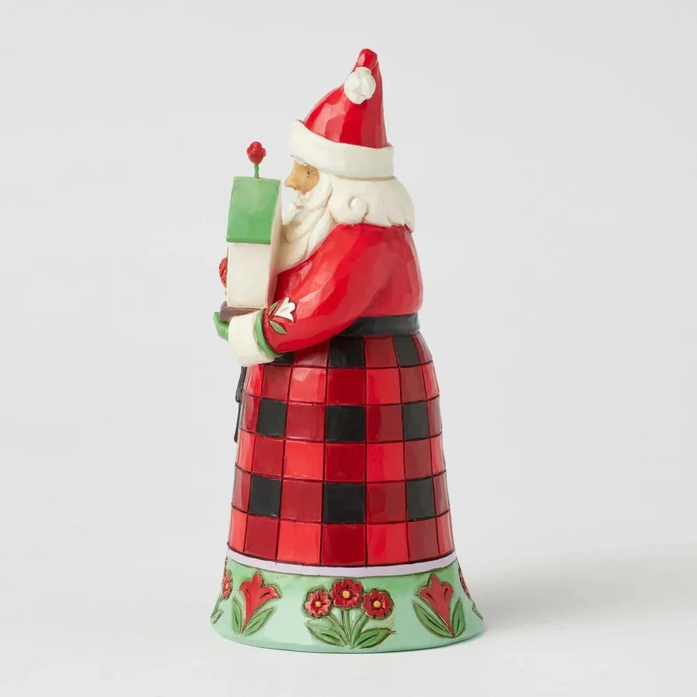 Opposite side view of a Jim Shore Santa figurine in a check robe cradling a birdhouse with a red cardinal on top