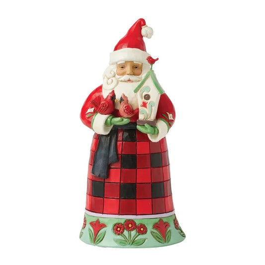 Front view of a Jim Shore Santa figurine in a red and black check robe holding two cardinals and a decorated birdhouse