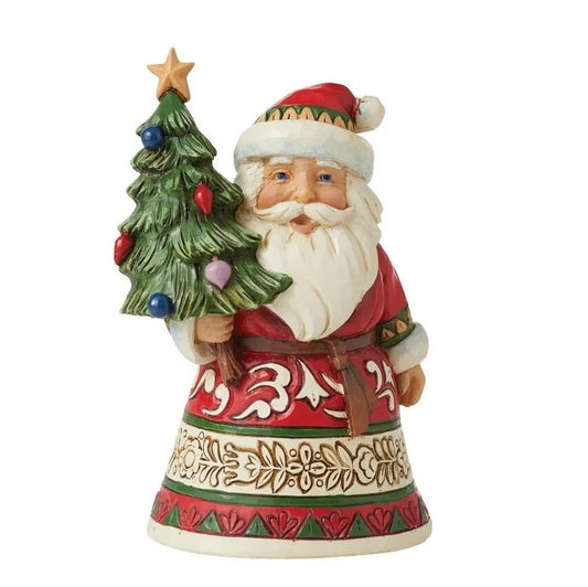 Front view of a small Santa figurine holding a decorated Christmas tree with star topper, scrollwork and holly-patterned robe