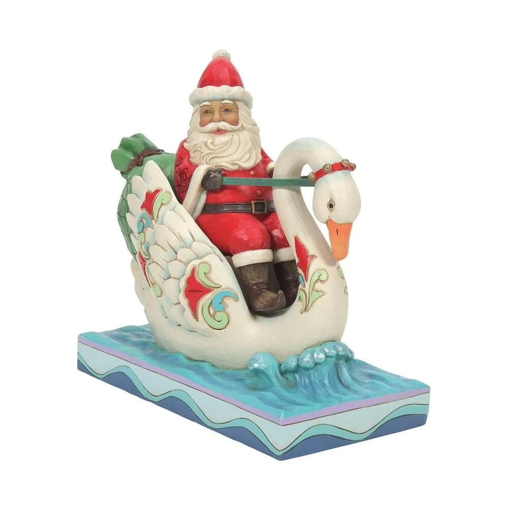 Front view of Santa figurine seated on a decorated swan, green gift sack behind, scrollwork wings, wave-patterned water base