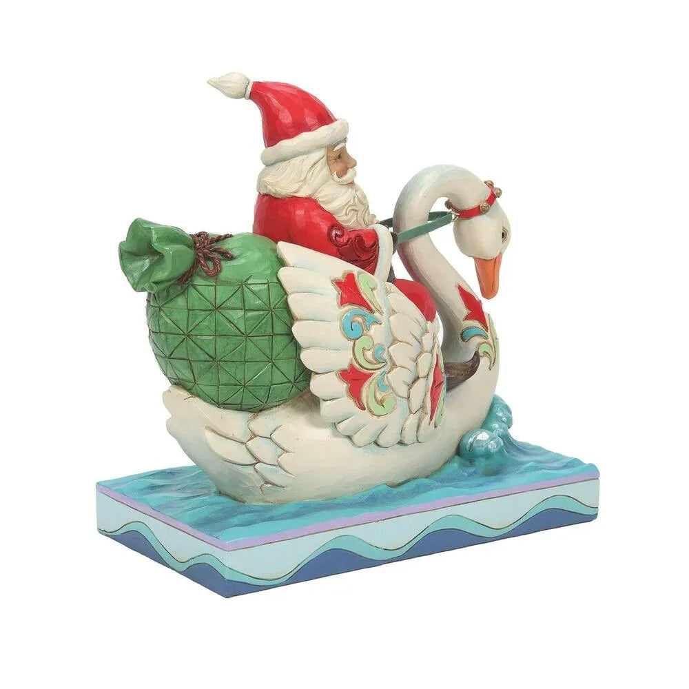 Side view of Santa figurine riding a swan with scrollwork wing detail, large green gift sack, wave-patterned water base