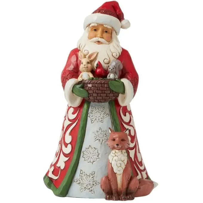 Santa figurine holding a basket with rabbit, cardinal and squirrel, fox seated at base, snowflake robe detail 