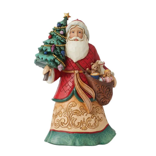 Front view of Santa figurine in red diamond coat holding a decorated Christmas tree and toy-filled satchel, gold scrollwork robe