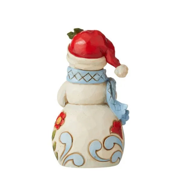 Rear view of snowman figurine in red Santa hat with pompom, blue diamond-patterned scarf, folk art floral scrollwork body 