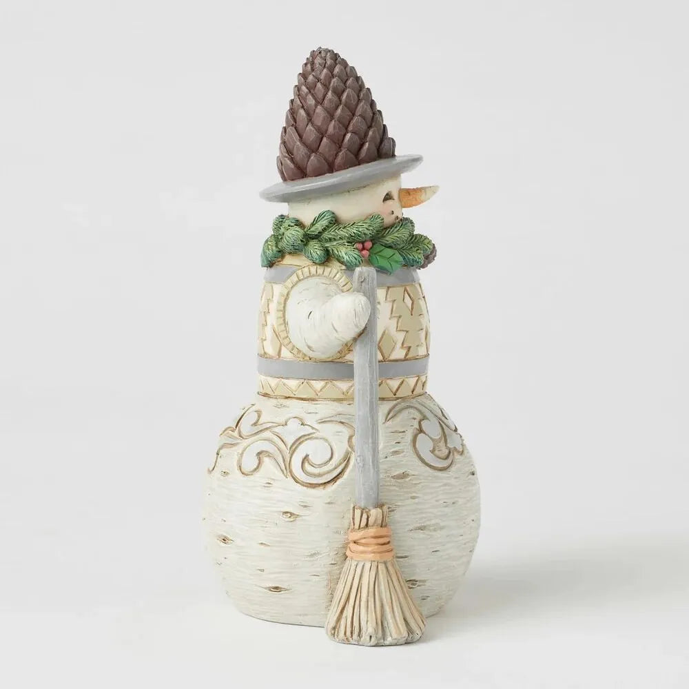 Left side view of woodland snowman figurine with pinecone hat, evergreen wreath collar, gold-patterned vest, scroll-detailed base