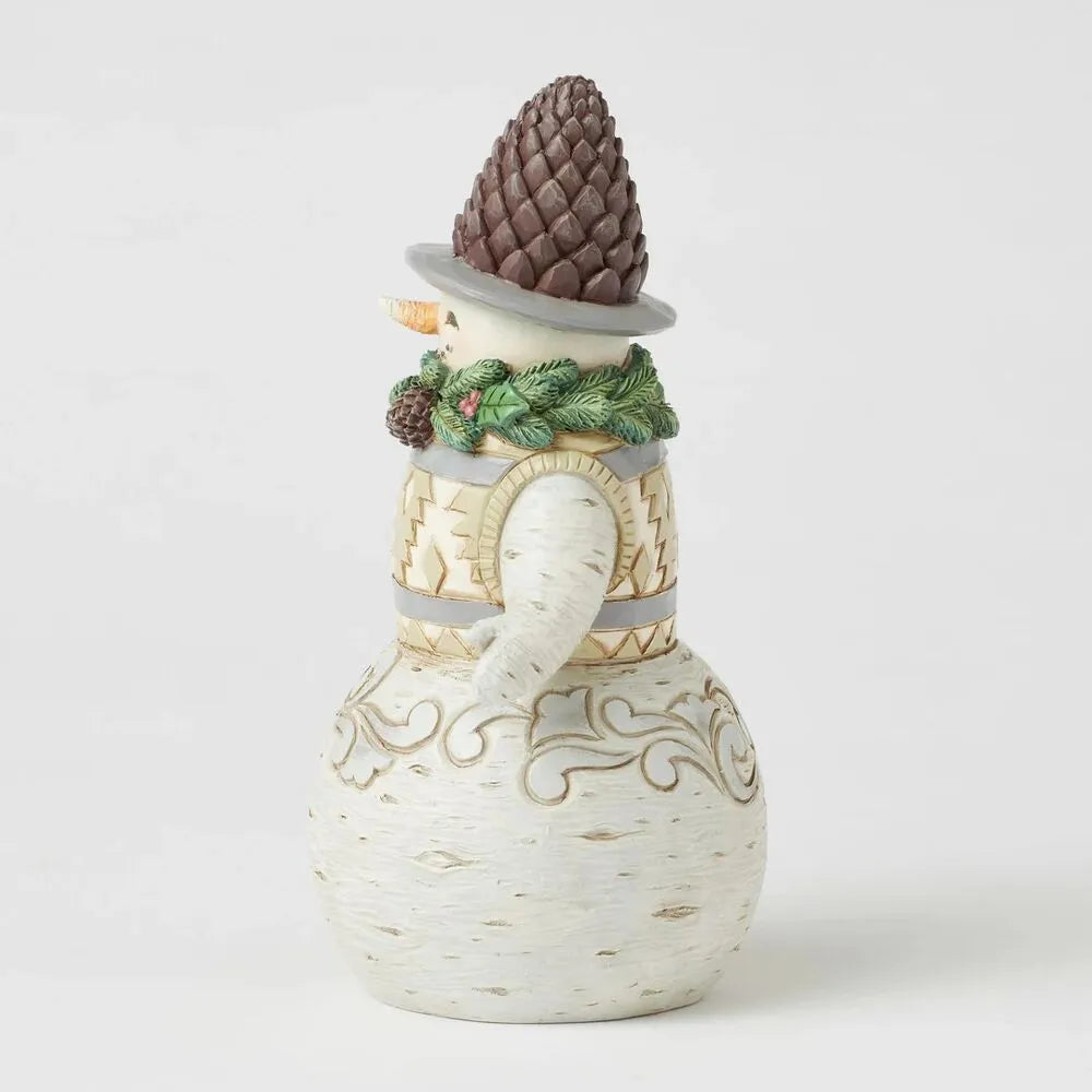 Right side view of woodland snowman figurine with pinecone hat, evergreen wreath collar, gold-patterned vest, broom, scroll base