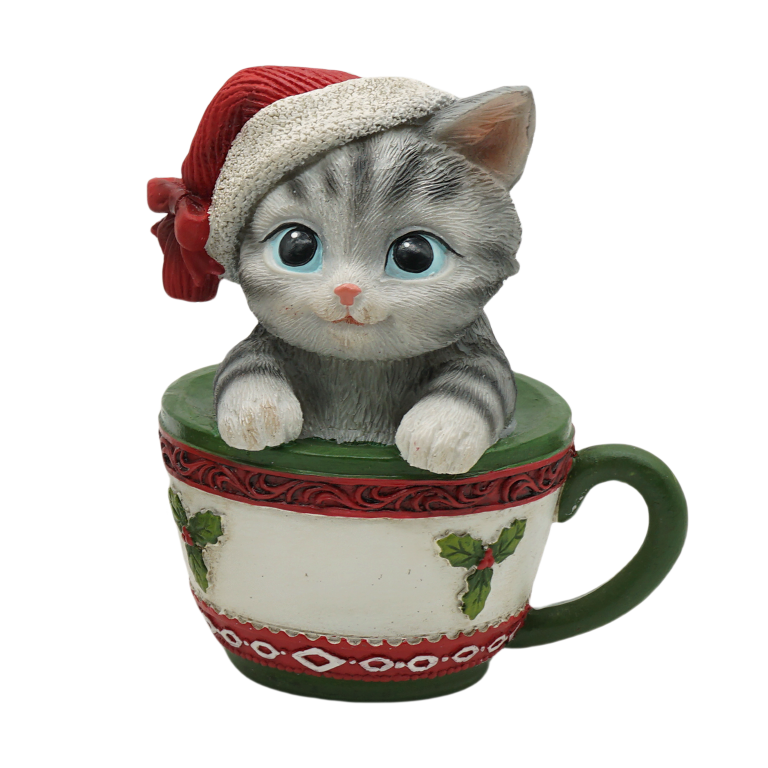 Grey tabby kitten in a Santa hat sitting inside a holly-decorated Christmas teacup figurine
