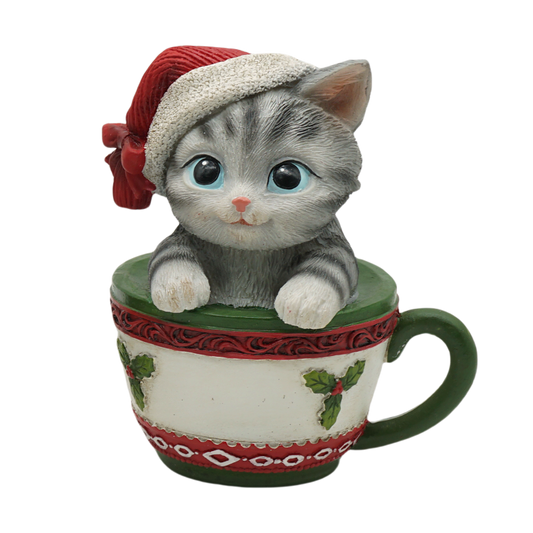 Grey tabby kitten in a Santa hat sitting inside a holly-decorated Christmas teacup figurine