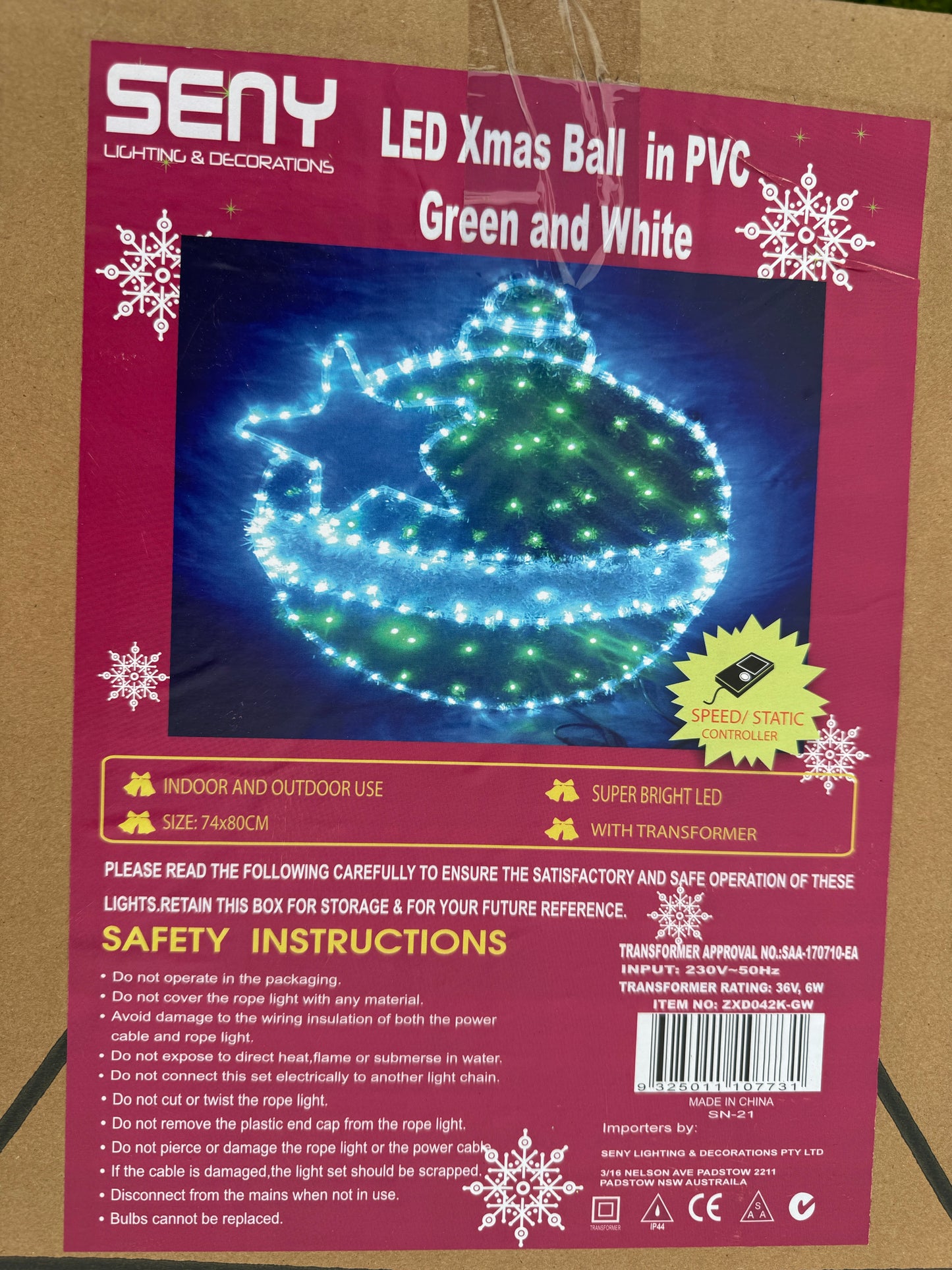 Illuminated green and white bauble-shaped Christmas light with star cut-out design