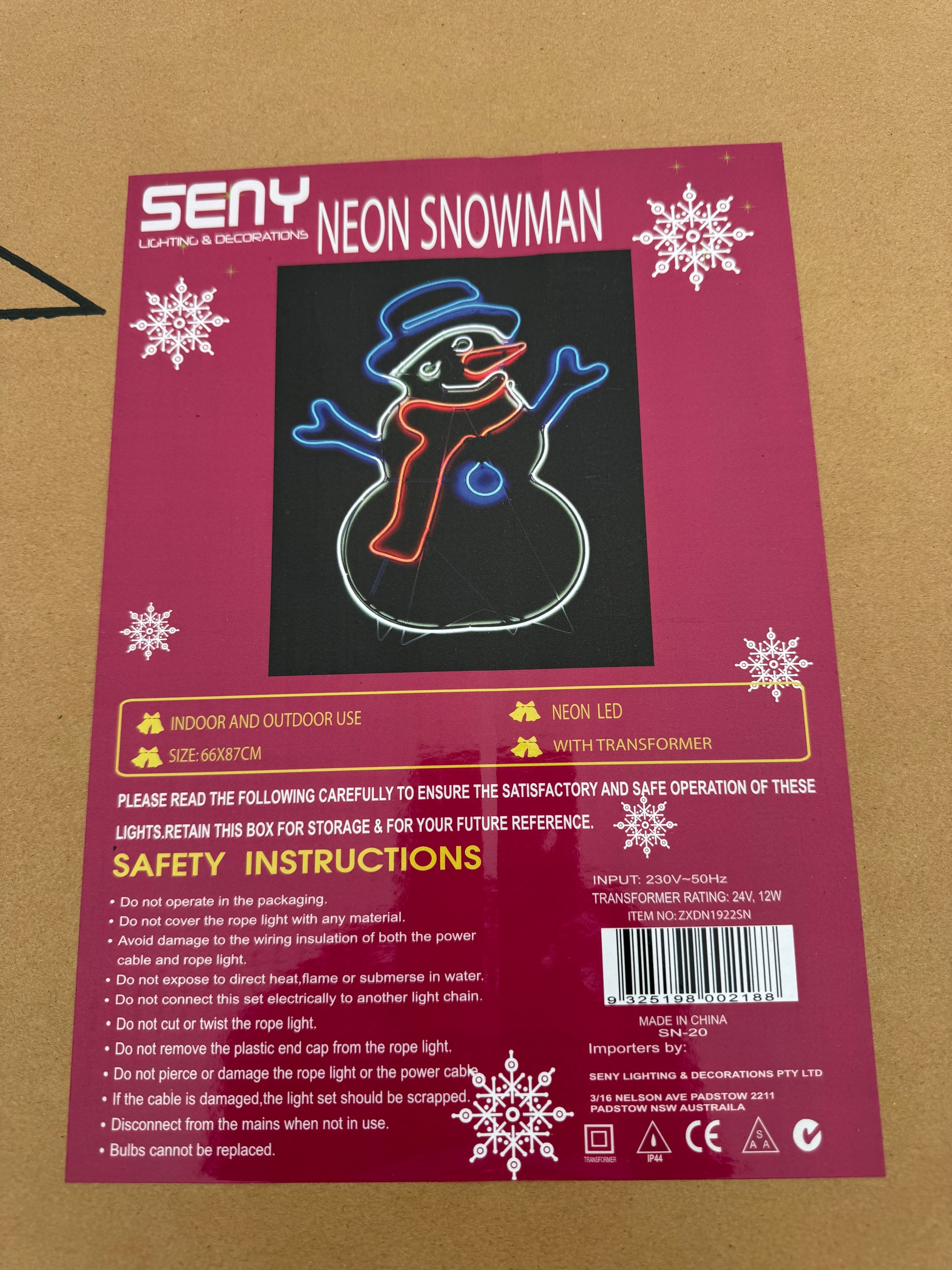 Neon-style LED snowman light with blue hat, red scarf, orange nose, and white outline