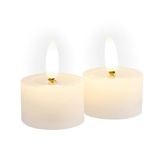 Set of two white LED tealight candles with realistic flickering flames glowing with warm light