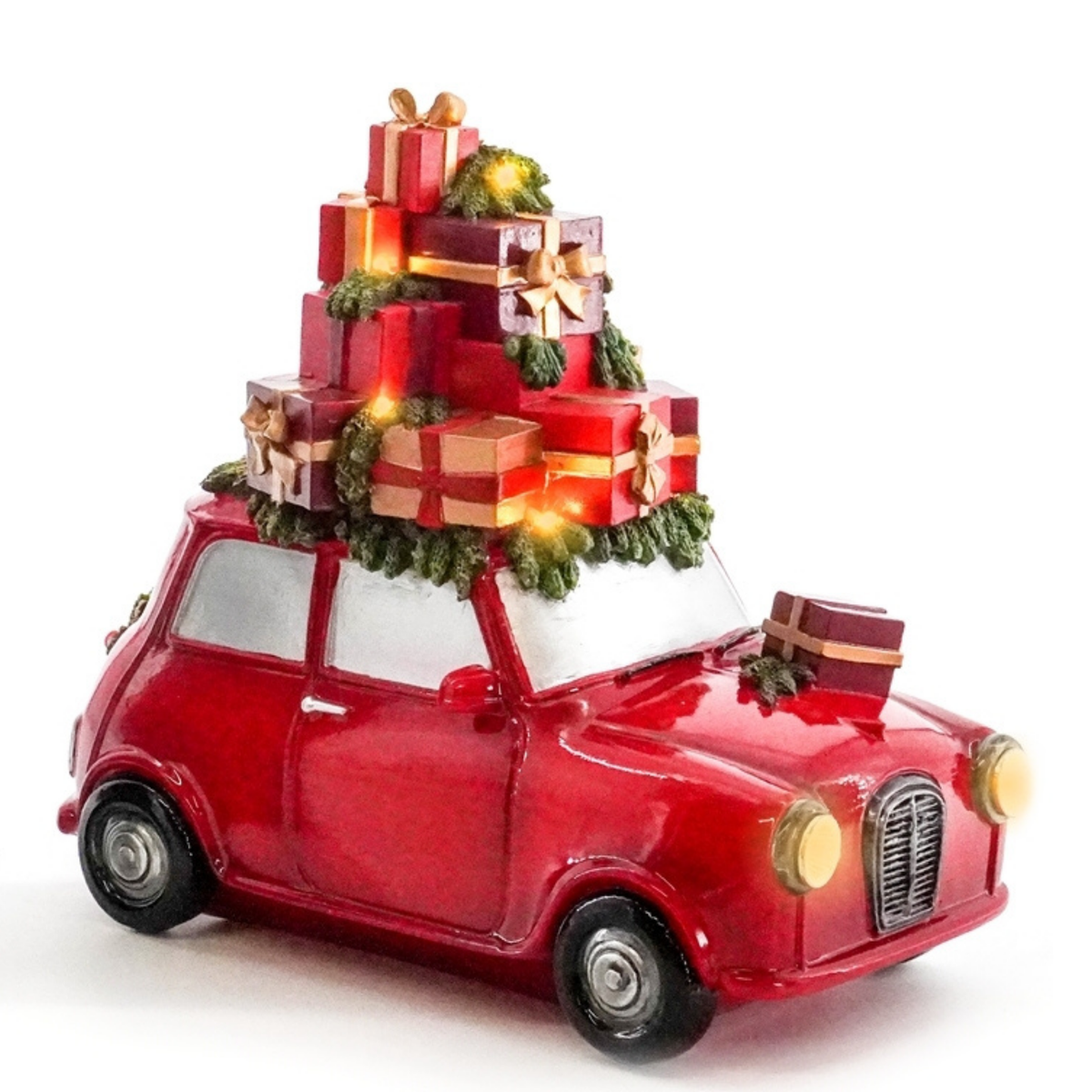 Light-up red Mini car decoration piled high with wrapped Christmas gifts and evergreen branches, with glowing headlamps