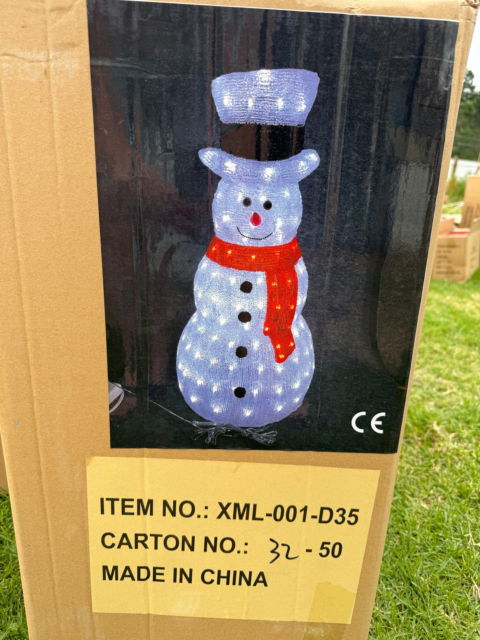 Light-up snowman with black top hat and red scarf glowing with white LED lights