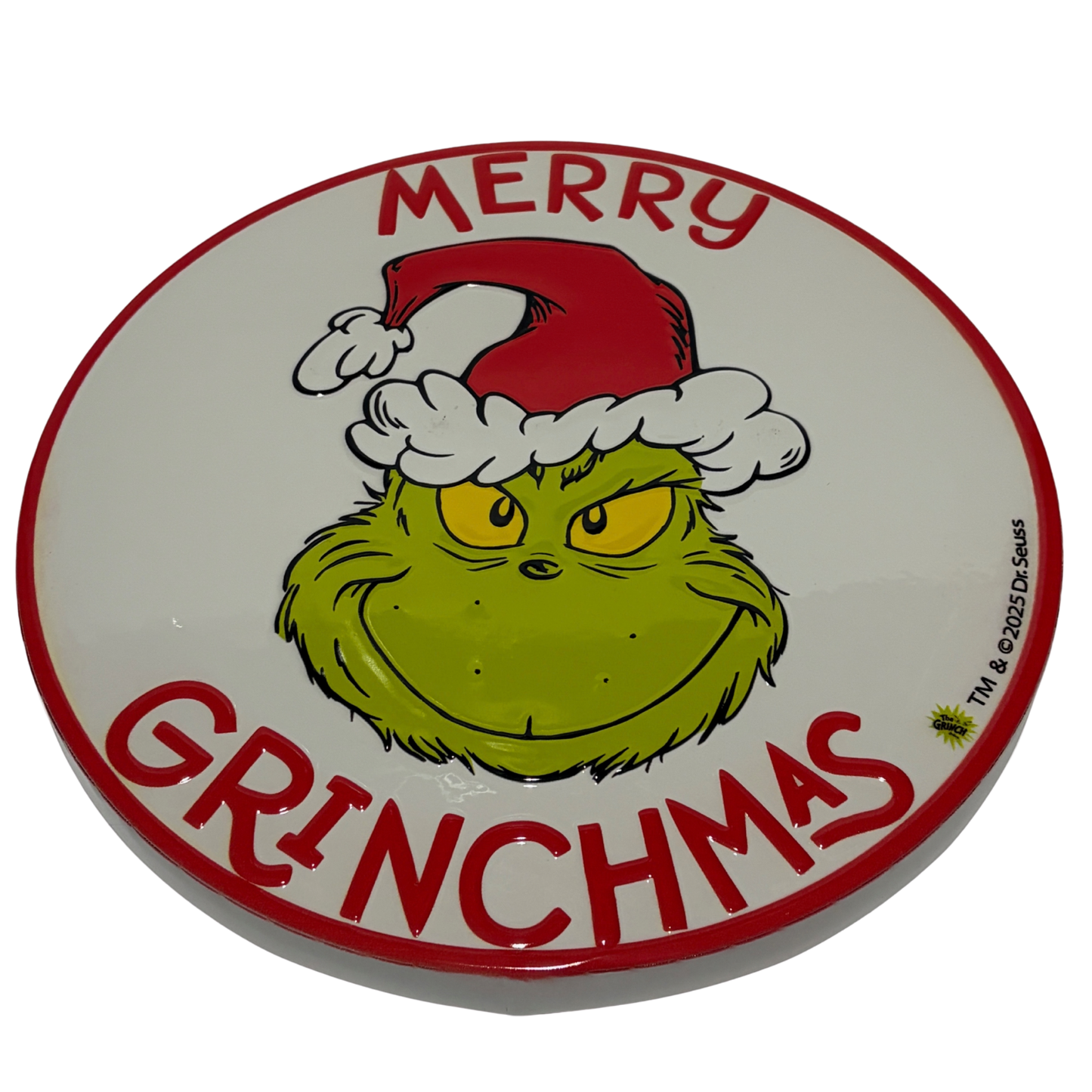 Round sign with the Grinch wearing a Santa hat and red “Merry Grinchmas” lettering around the edge