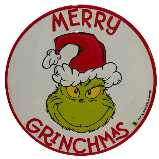Round sign with the Grinch wearing a Santa hat and red “Merry Grinchmas” lettering around the edge