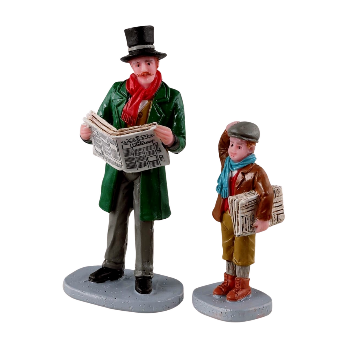 Set of two Christmas village figurines: a man in top hat reading a Gazette newspaper and a boy newsboy carrying papers