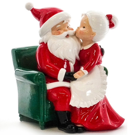Polished resin Mr and Mrs Claus decoration with Santa in armchair and Mrs Claus kissing his cheek