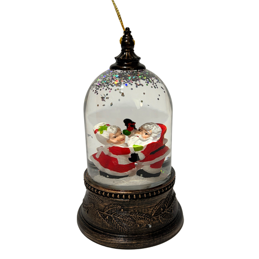Mini lantern with Santa and Mrs Claus inside a glass dome with swirling glitter and a bronze base