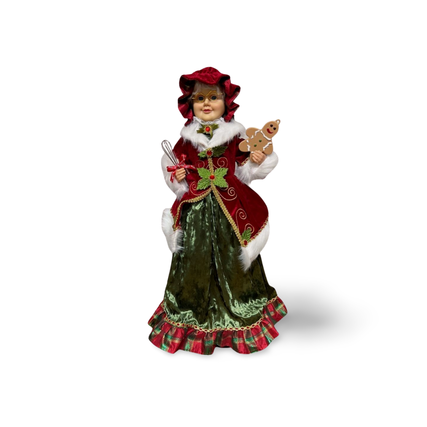 Mrs. Claus figurine wearing a red velvet coat, green skirt, and bonnet, holding a gingerbread man and whisk, with gold glasses and festive accents.