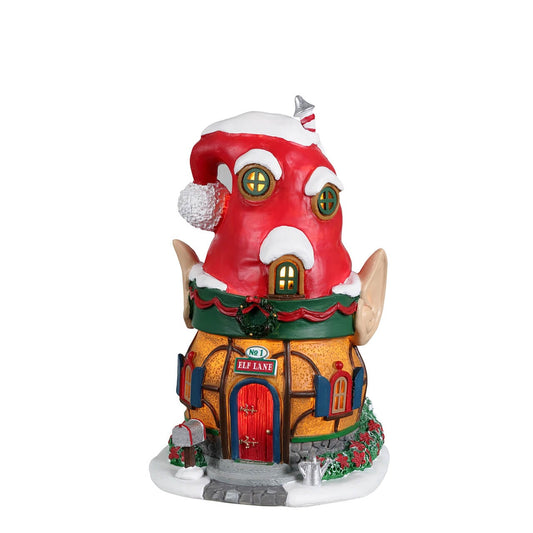 Lemax Elf Lane house shaped like a Santa hat with elf ears, snowy roof and lit windows