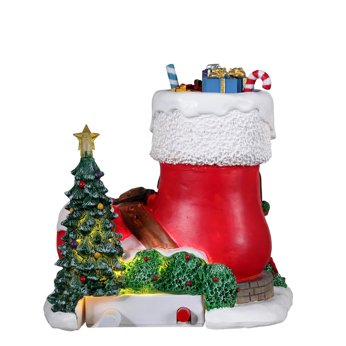 Side view of Lemax stocking-shaped house with wreath window, lit and decorated with tree