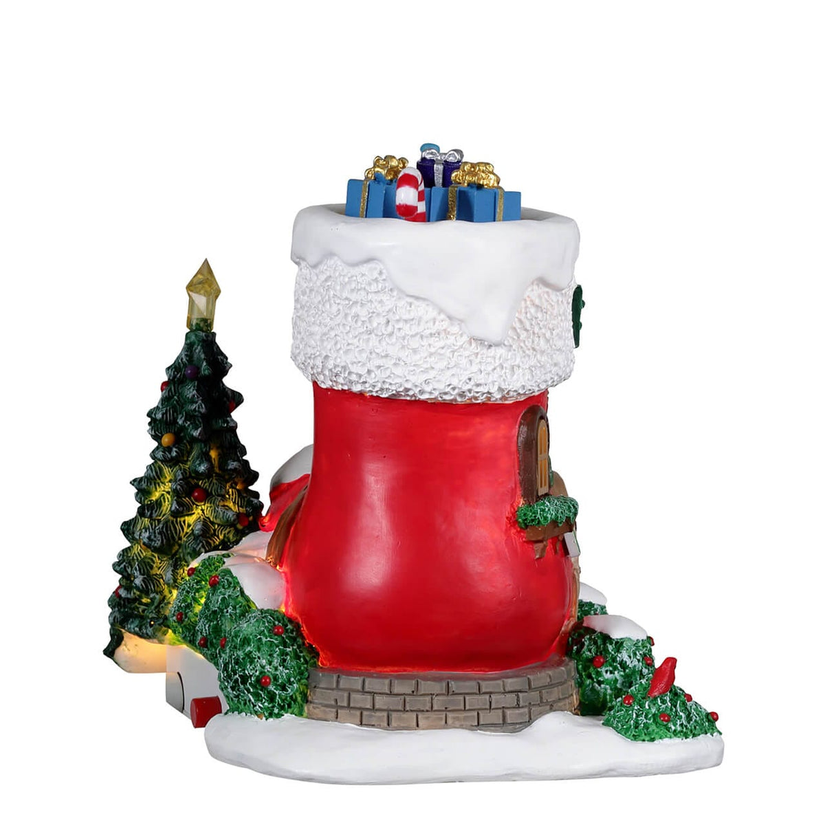 Rear view of Lemax stocking house showing patchwork detail and lit Christmas tree