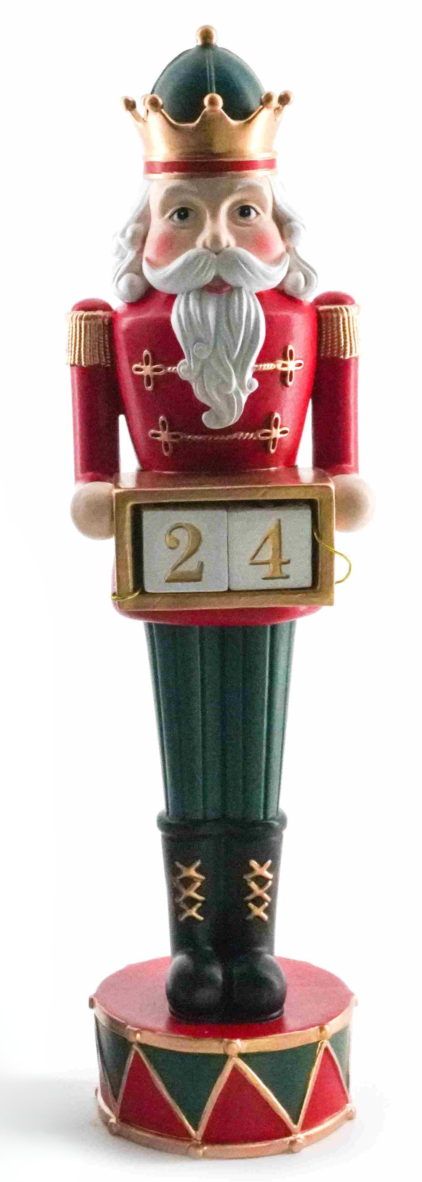 Traditional red and green nutcracker figurine holding countdown blocks showing number 24