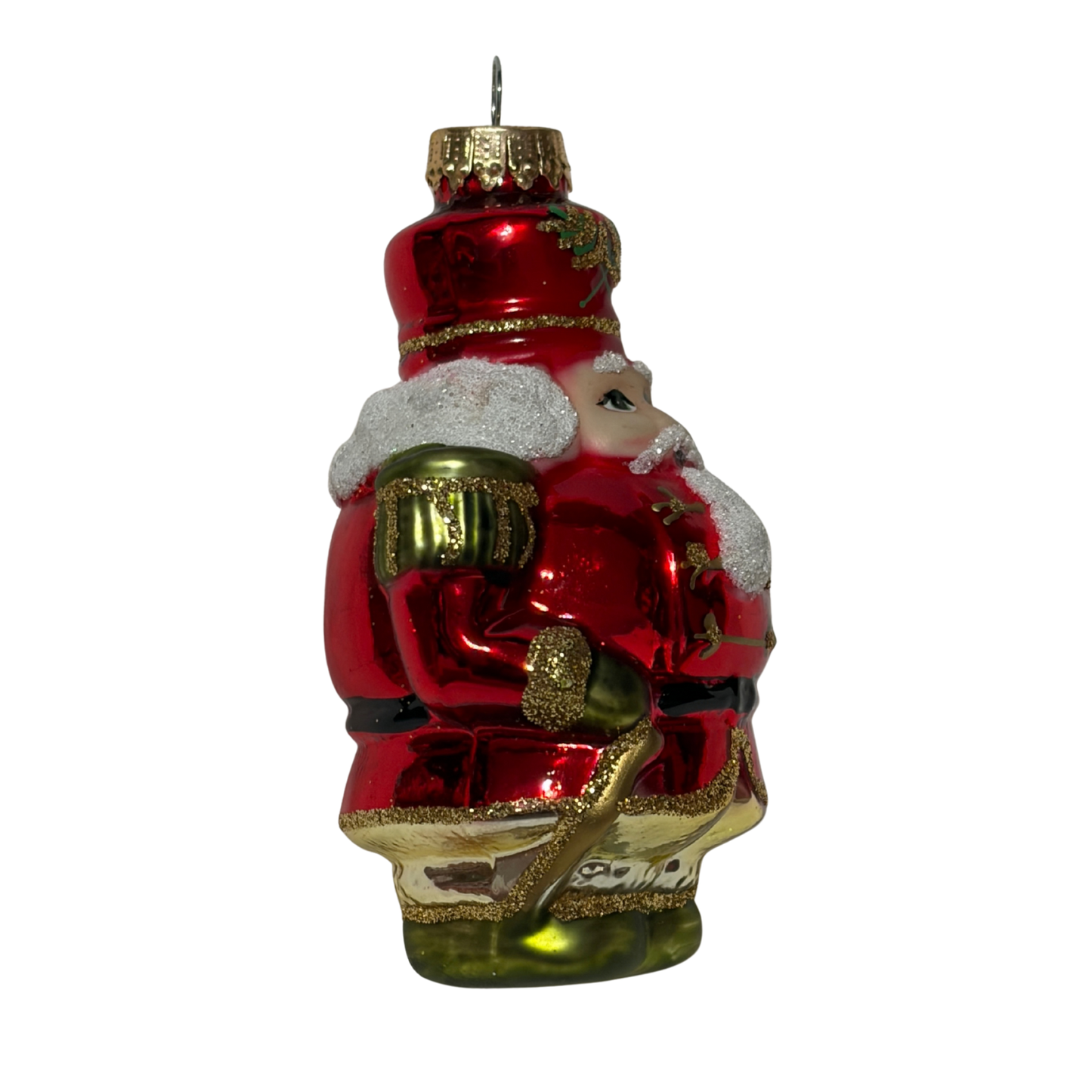 Red nutcracker Christmas tree decoration wearing a red and gold uniform with green accents