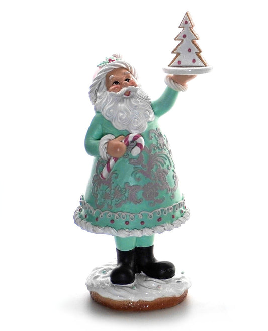 Pastel Santa figurine in mint-green coat holding a Christmas tree on a plate and a candy cane