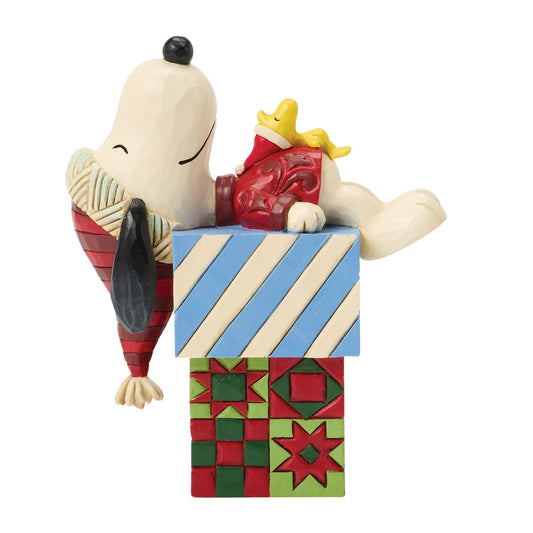 Snoopy and Woodstock Christmas figurine, Snoopy lying on stacked gift boxes with blue stripe and red quilt folk art patterning