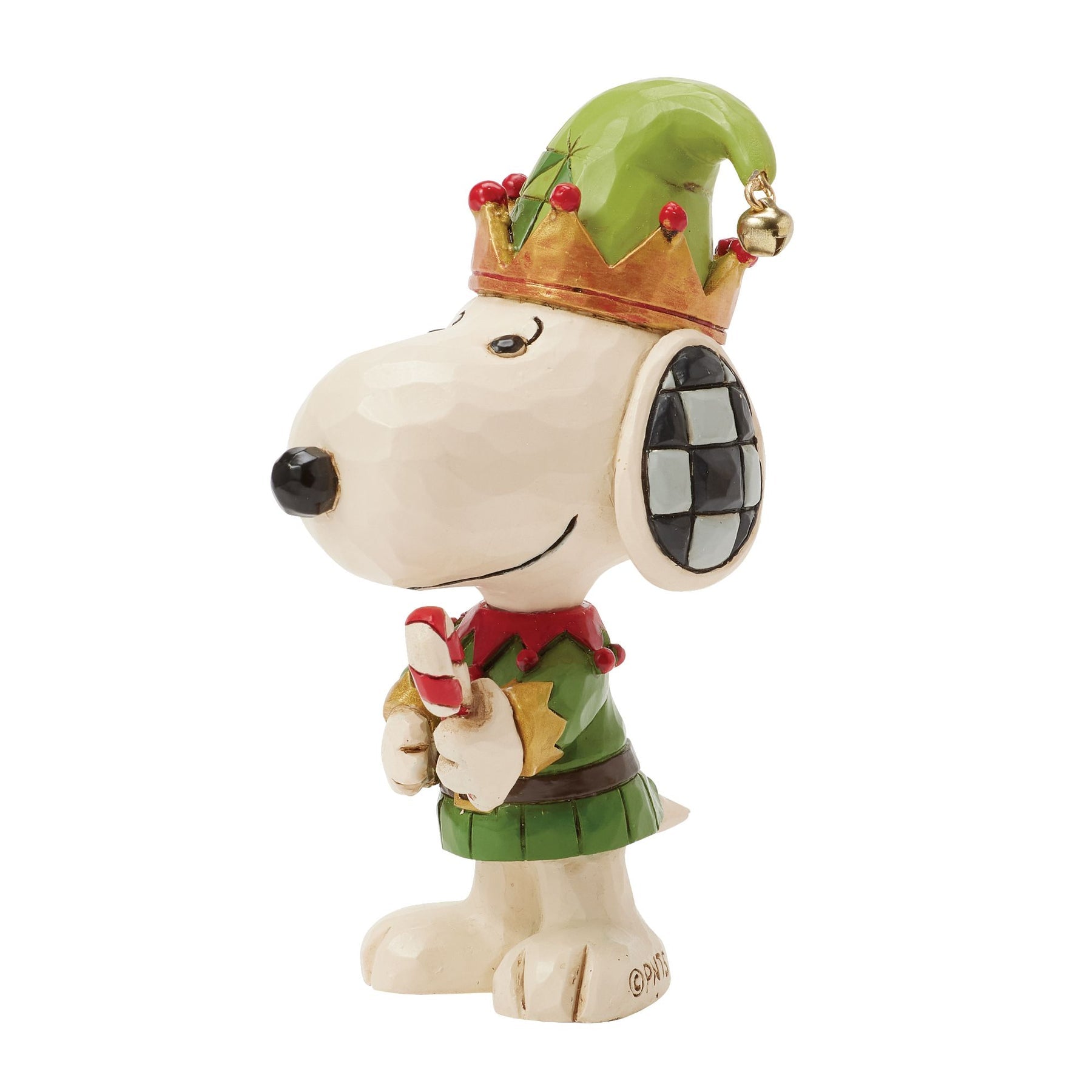 Low-angle right profile of Snoopy elf figurine in green and red costume with crown-brim hat, gold bell, holding candy cane