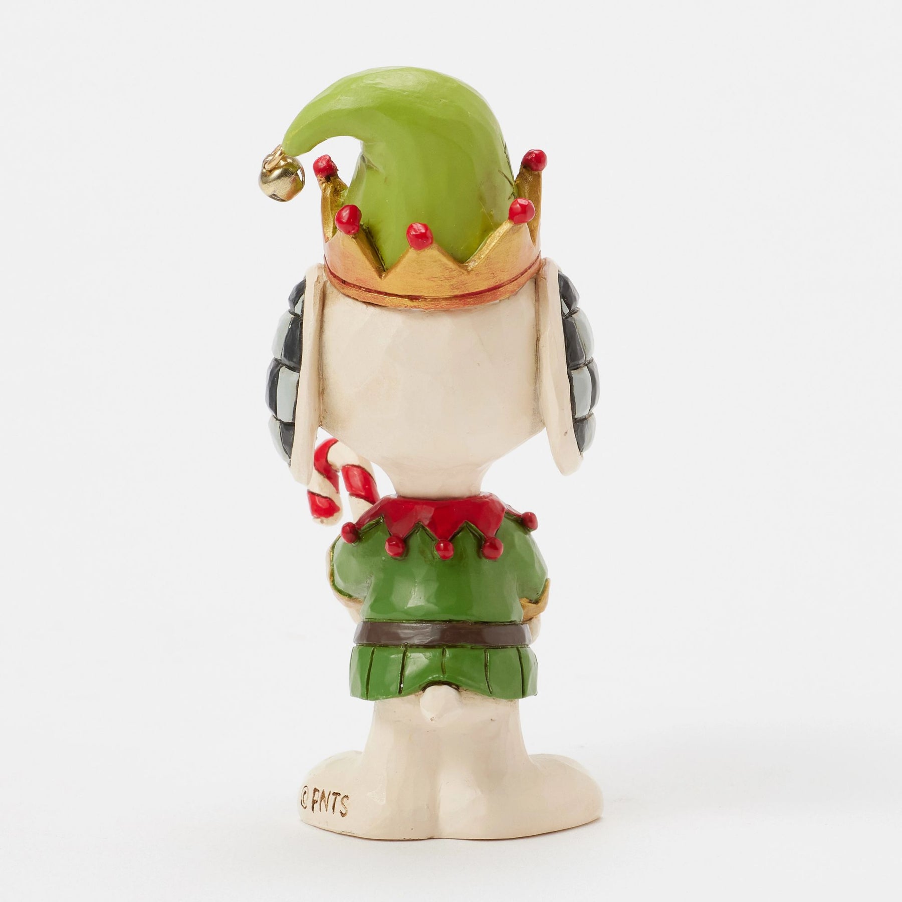Rear view of Snoopy elf figurine showing green hat with gold bell, checkered ears, red and green costume, candy cane