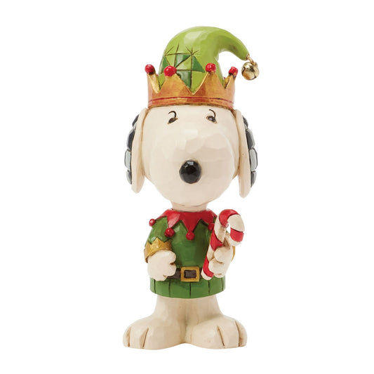 Front view of Snoopy elf figurine in green and red jester costume with gold crown-brim hat, bell, holding candy cane