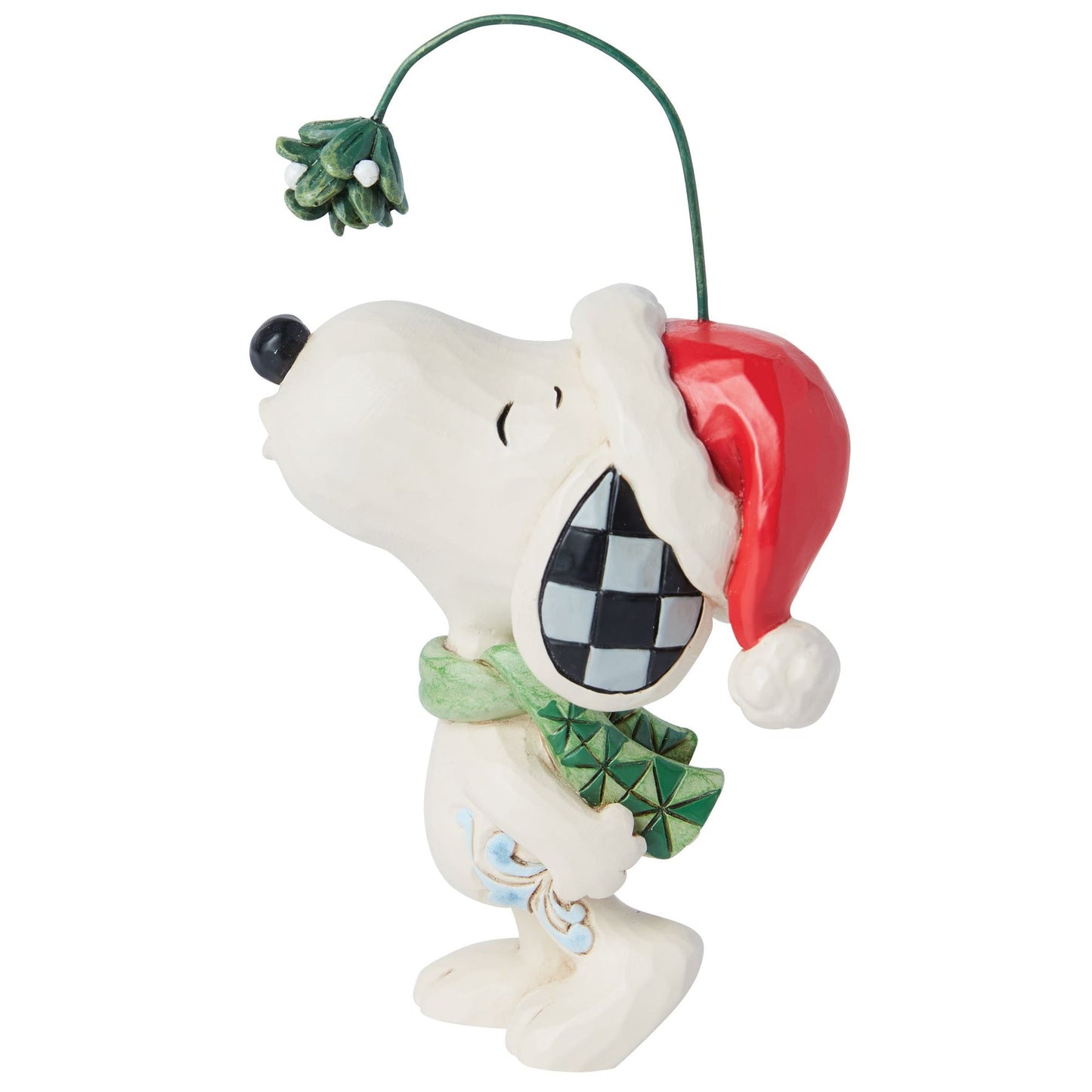Right side view of Snoopy figurine in Santa hat and green scarf, nose raised toward mistletoe on a wire