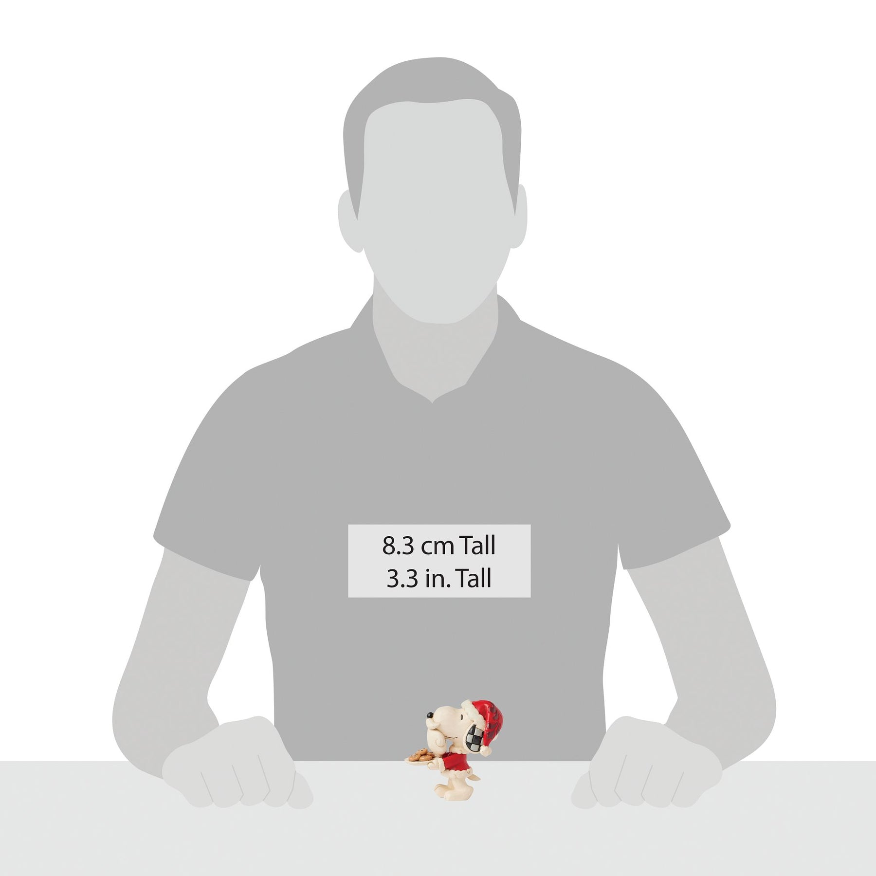 Snoopy Santa figurine shown beside human silhouette for scale, measuring 8.3 cm / 3.3 inches tall