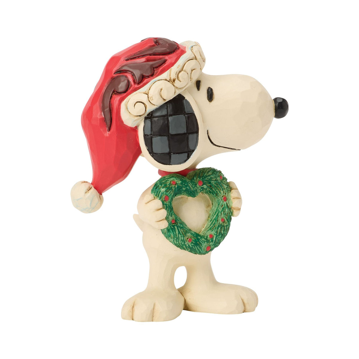 Front view of Snoopy Christmas figurine in red scrollwork Santa hat, holding green heart-shaped wreath with red dot detailing