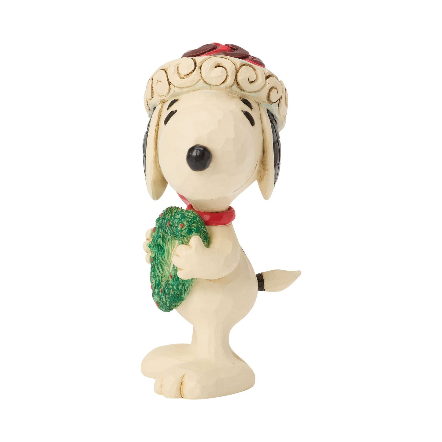 Right side view of Snoopy Christmas figurine, red Santa hat with cream scrollwork trim, holding green heart-shaped wreath, tail visible