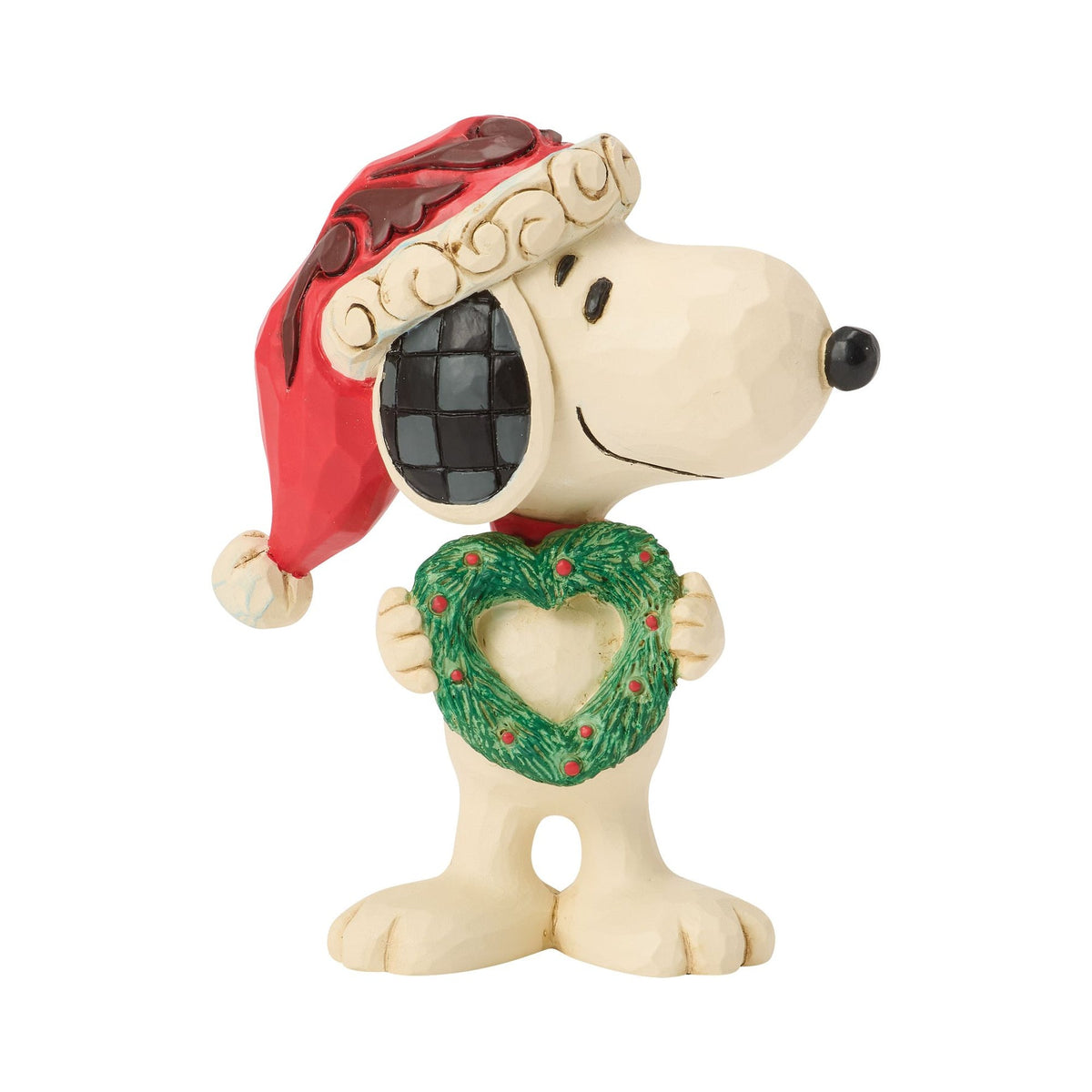 Left side view of Snoopy Christmas figurine in red scrollwork Santa hat, holding a green heart-shaped wreath with red dot detail