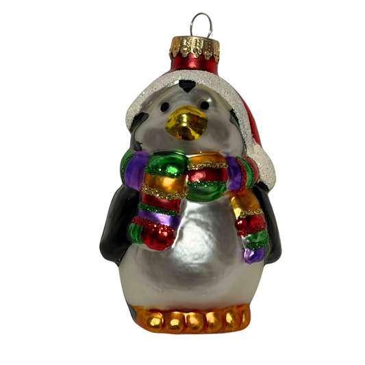 Penguin Christmas tree decoration wearing a red Santa hat and colourful striped scarf
