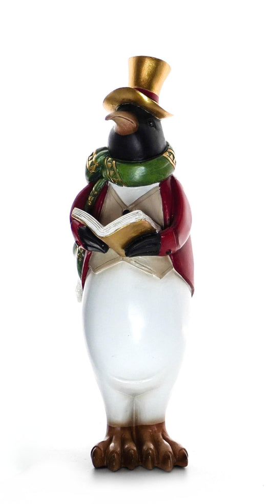 Penguin figurine wearing red jacket, green scarf, and gold top hat holding a songbook