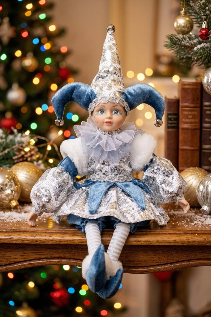 Blue and silver jester figurine in sequinned costume with peaked hat and fur-trimmed sleeves