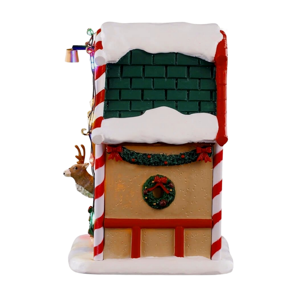 Left view of Prancer's reindeer stable village building with green-tiled roof, candy cane column, reindeer peeking out, and coloured lights