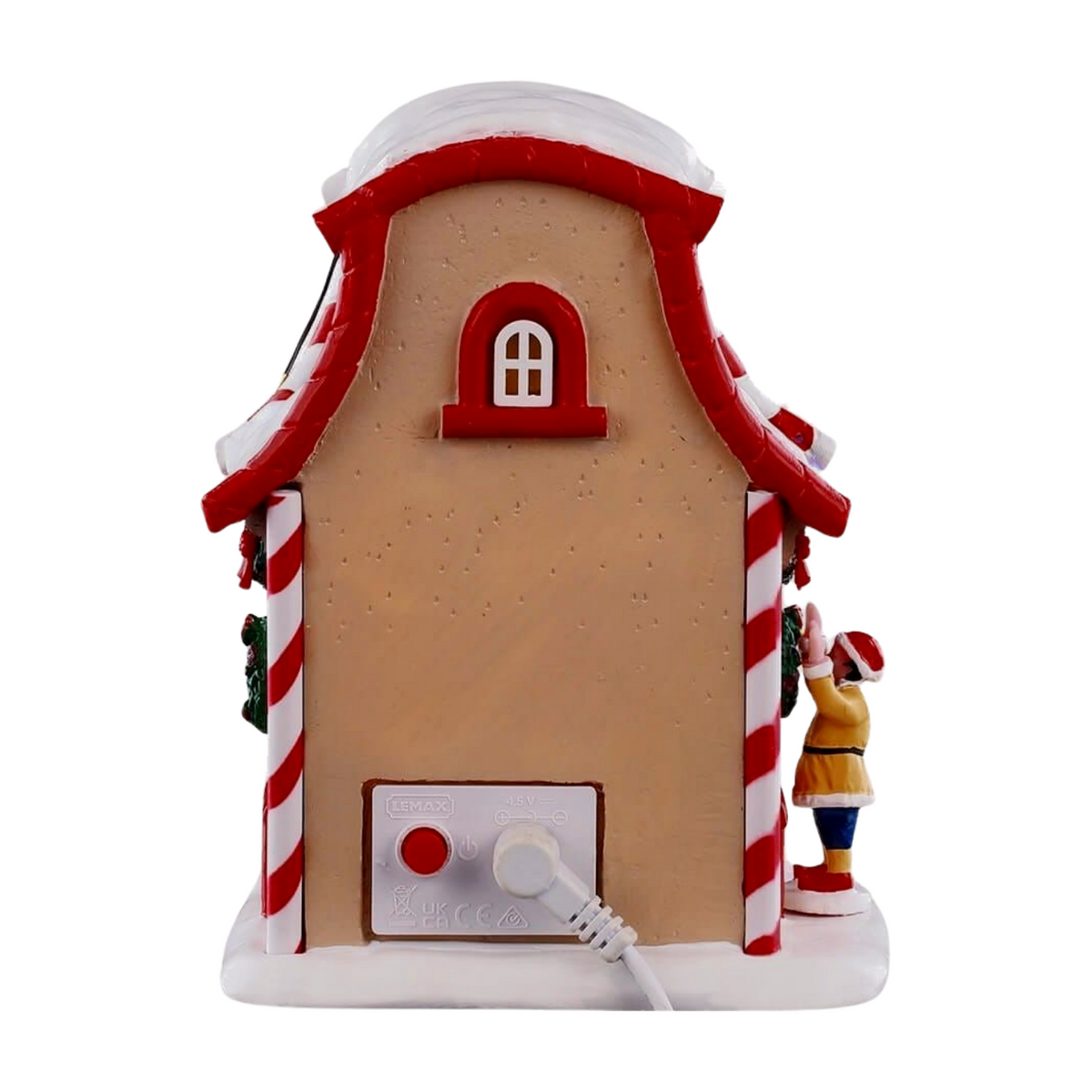 Rear of Prancer's reindeer stable Christmas village building with candy cane columns, red arched window detail, and power connector at base